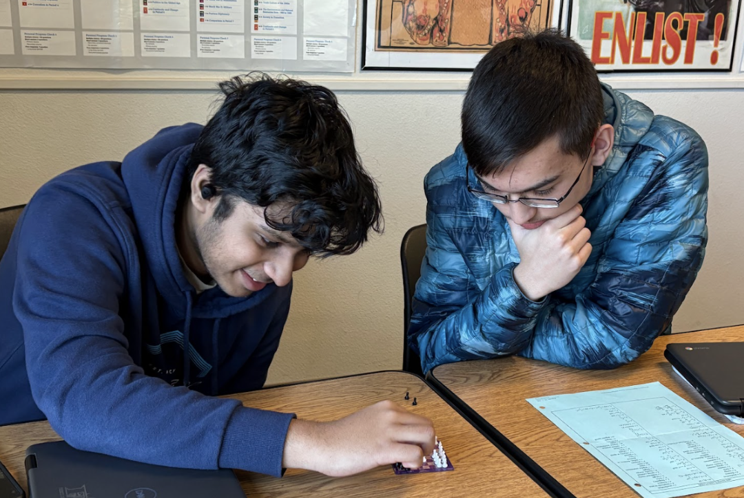 Sophomore Samarth Rudrappa (left) plays chess with junior Brandon Thames (right) during the break. They tied after playing two games.
